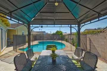 Covered outdoor dining area overlooking the private pool