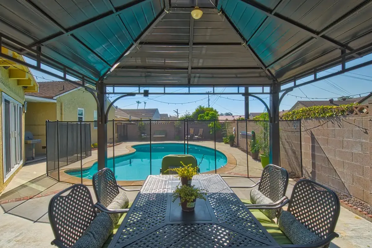 Covered outdoor dining area overlooking the private pool