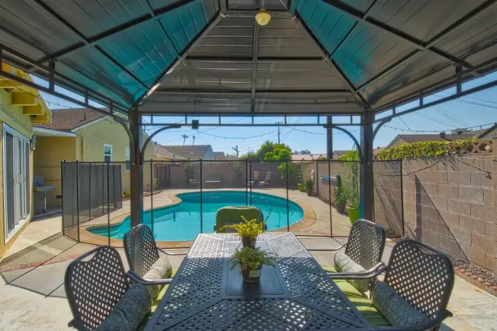 Covered outdoor dining area overlooking the private pool
