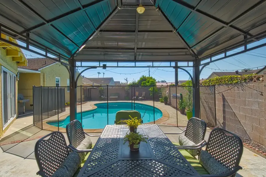 Covered outdoor dining area overlooking the private pool